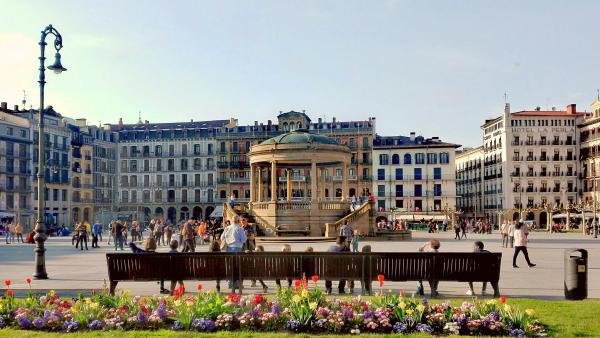 Castle square with people and flowers